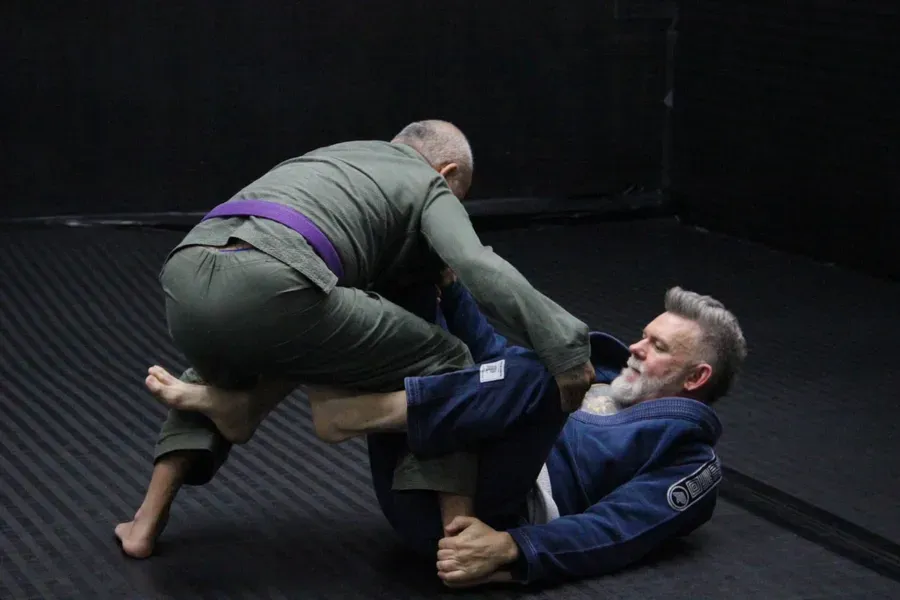 Adults training live jiu-jitsu at Ethos BJJ