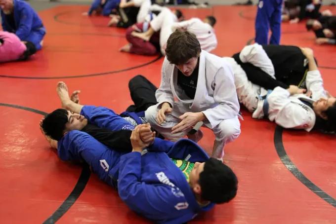 Tyler Schuckman coaching on the mats
