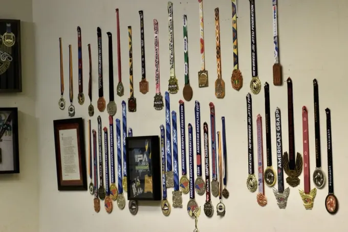 Wall of medals and trophies at Ethos BJJ