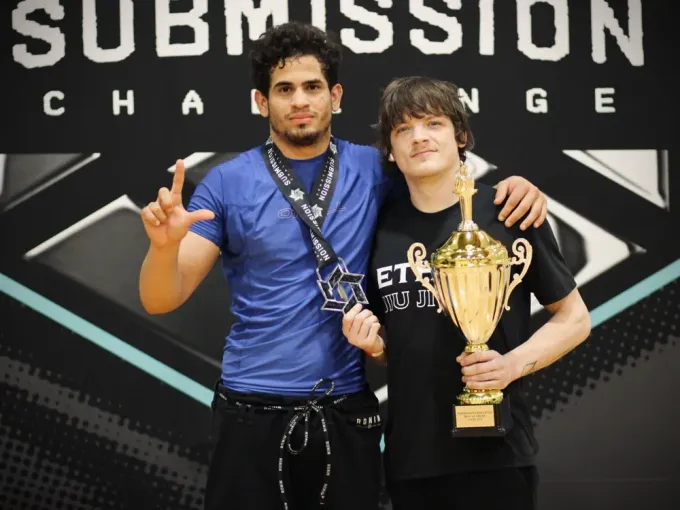 Ethos competitor with trophy on the podium