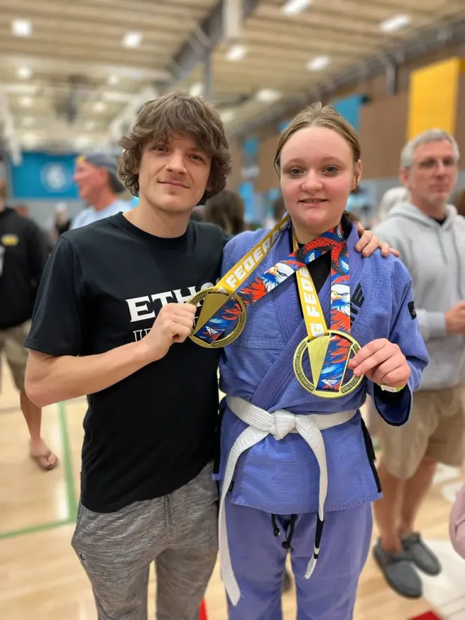 Young Ethos student with competition medals